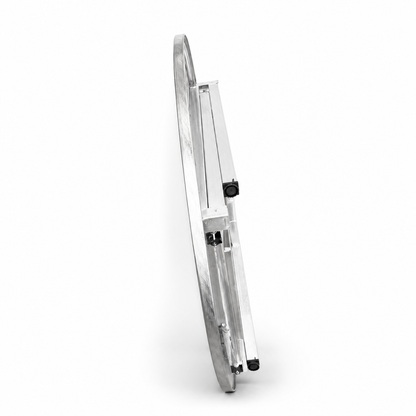 MARU grill table folded flat and standing on edge, showing its slim storage profile