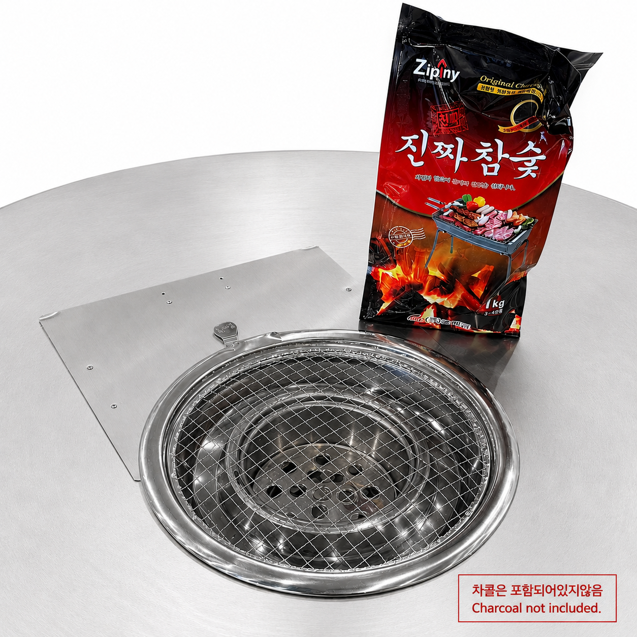 Close-up of the MARU charcoal insert and mesh grate beside a 1kg bag of Korean oak charcoal, not included